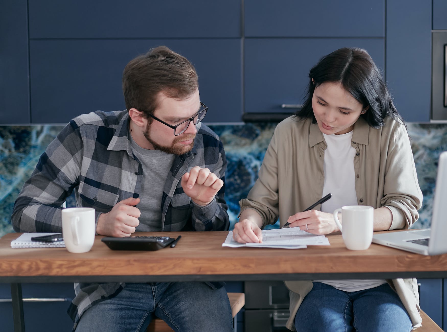 a couple having conversation while looking at the documents